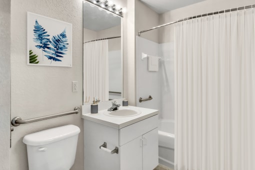 Bathroom with large mirror and vanity lighting
