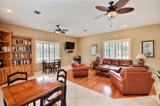 Clubhouse Interior With Large Leather Couch, Bookshelf at River Park Place Apartments, Florida, 32962