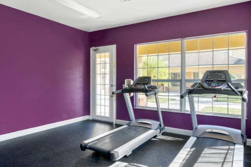 Fitness Center with Purple Walls, Exercise Equipment  and Windows