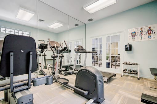 Fitness center with cardio equipment, dumb bell free eights and large mirror wall