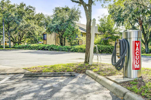 Car Vacuum Next to Parking Lot and Trees