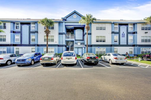 Building Exterior with Parking Lot and Cars