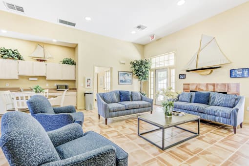 a resident clubhouse with couches and chairs and a coffee table