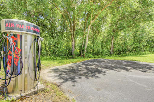a public phone booth with trees in the background