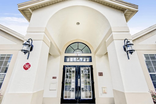 The entrance to the leasing office featuring 2 large black doors.
