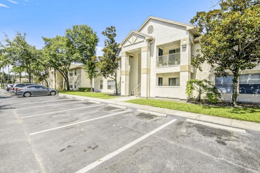 Building exterior with a parking lot in the front of it.