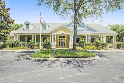 Leasing Office Exterior with Parking Lot, Sidewalk and Plants