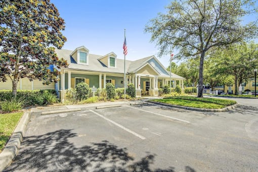 Leasing Office Exterior with Parking Lot, Sidewalk and PLants