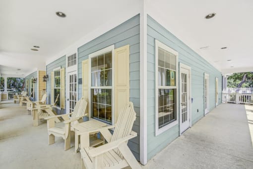 Clubhouse Exterior Shaded Patio with White Patio Chairs