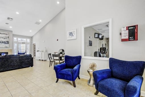 Leasing Office Entry with  Armchairs and Dining Table with Chairs and Couch in the Background