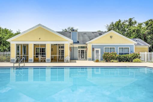 Swimming Pool with Sun Deck Next to Yellow Leasing Office