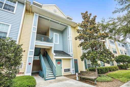 Apartment Building Exterior with Stairs Surrounded by Plants