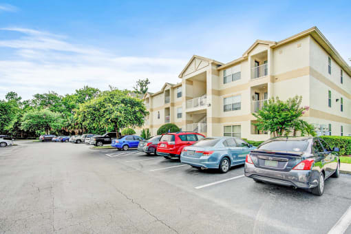 Building Exterior surrounded by shrubbery and trees with view of parking lot