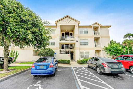 Building Exterior surrounded by shrubbery and trees with view of parking lot