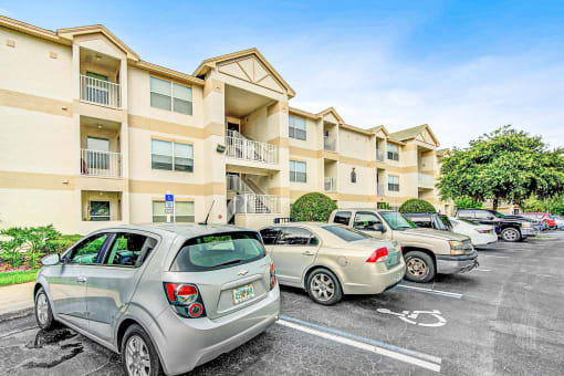Building Exterior surrounded by shrubbery and trees with view of parking lot