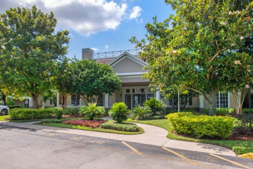 Parking Lot and Walkway in Front of Leasing Office Surrounded by Shrubs