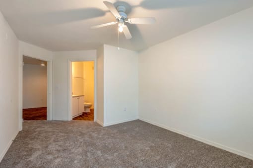 Carpeted Bedroom with Ceiling Fan and En-Suite Bathroom