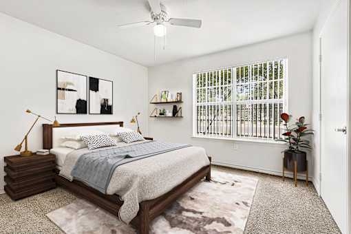 Bedroom with large windows and ceiling fan at Tierra Antigua Apartments, ARIZONA