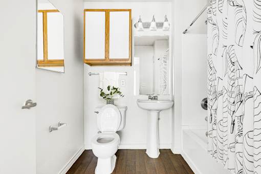 Bathroom with wood accents and pedestal sink at Tierra Antigua Apartments, ARIZONA