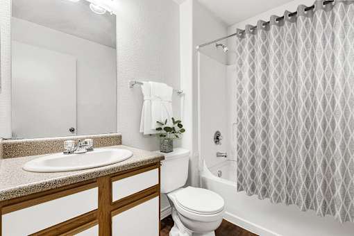 Bathroom with tub shower combination and towel bar at Tierra Antigua Apartments, Mesa, AZ 85207