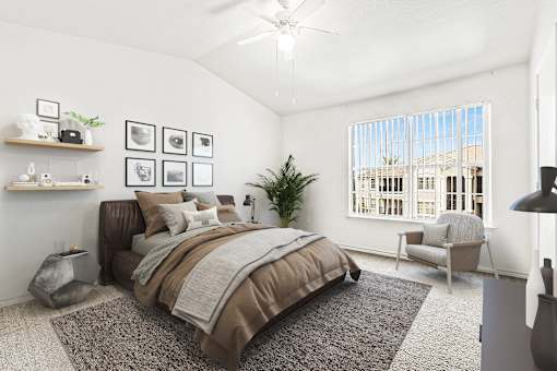 Spacious bedroom with vaulted ceiling and large window at Tierra Antigua Apartments, Mesa, AZ