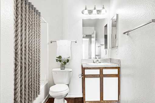Bathroom with granite vanity and modern fixtures at Tierra Antigua Apartments, Mesa, ARIZONA