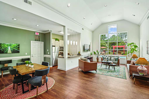 A well-lit, spacious living room with a dining table and chairs.