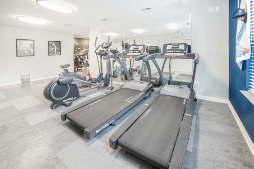 Fitness center with cardio equipment and mirrored walls