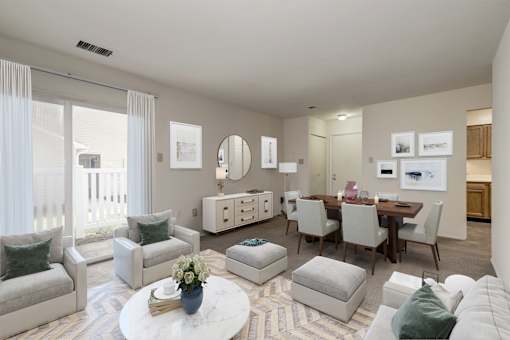 a staged living room and dining room with carpeted flooring and a large sliding glass door leading to a patio