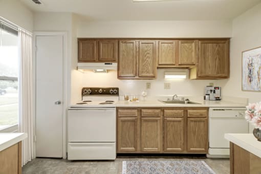 a kitchen with white appliances and wooden cabinets