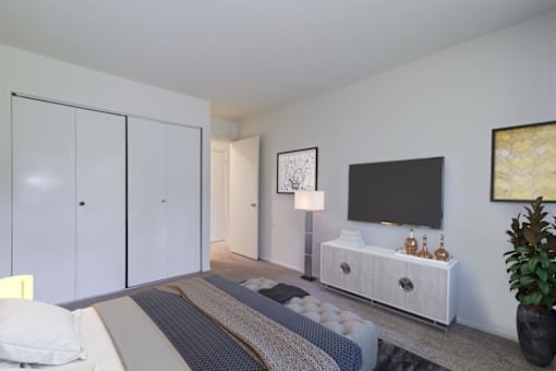 staged bedroom with carpeted flooring and closet with sliding doors