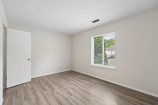 A room with a window and a door.