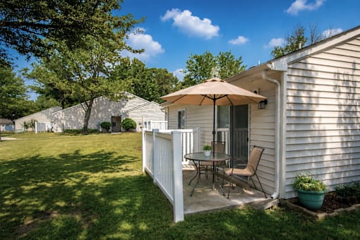 apartment patio with a white fence