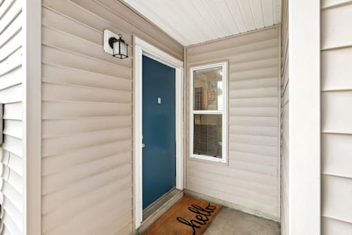 apartment door with a small window next to it