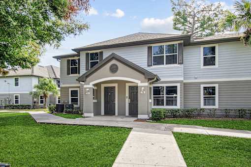 A house with a grey front and a black door.