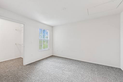 Empty room with a window and a door.