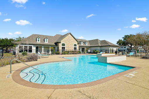 a swimming pool with a house in the background