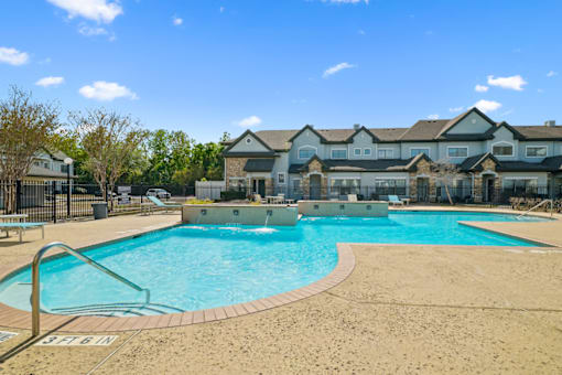 a swimming pool with a building in the background