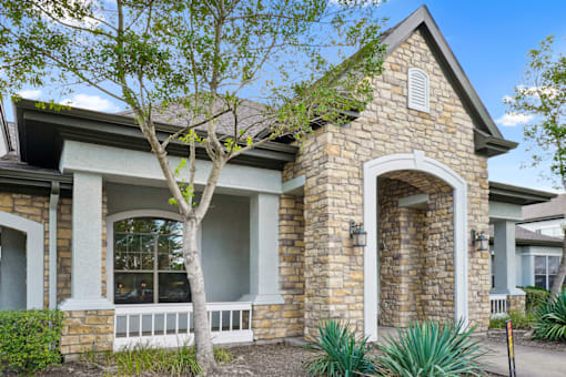 a stone house with a tree in front of it