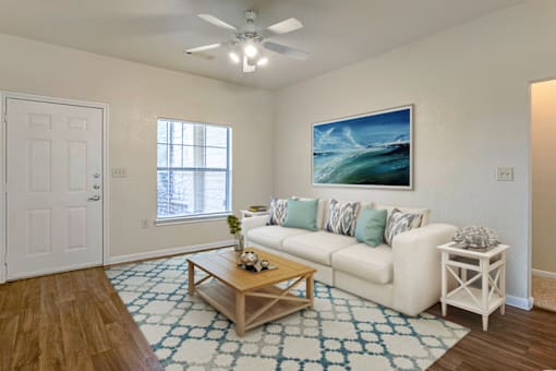 a living room with a white couch and a coffee table