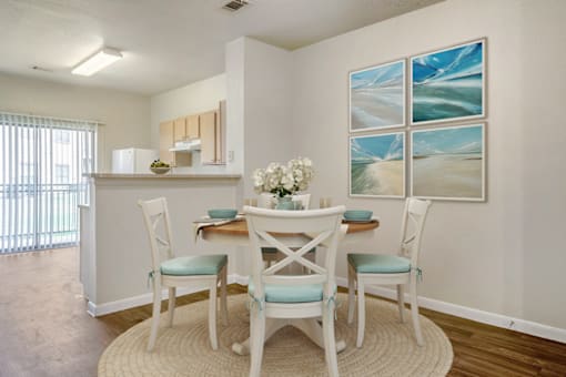 a dining room with a table and chairs