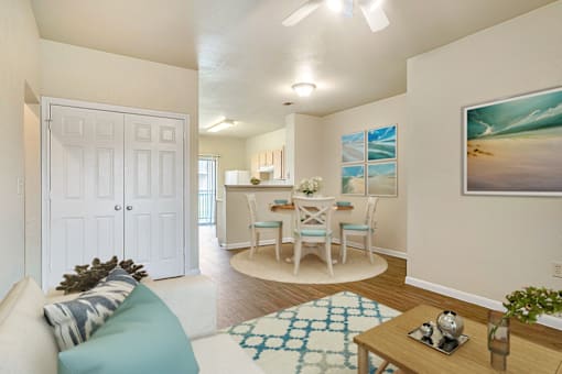 an open living room and kitchen with a table and chairs