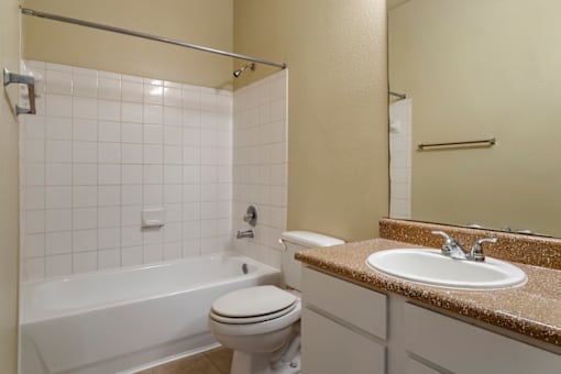 a bathroom with a sink toilet and a bath tub