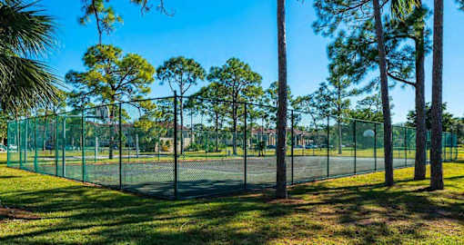 Fenced in Tennis Courts Surrounded by Trees