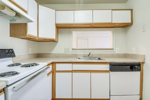 a kitchen with white cabinets and white appliances