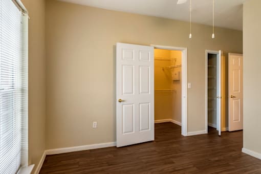 a bedroom with a closet and an open door