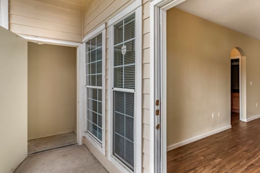 a bedroom with french doors and hardwood floors