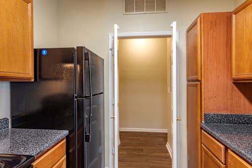 a kitchen with black appliances and wooden cabinets