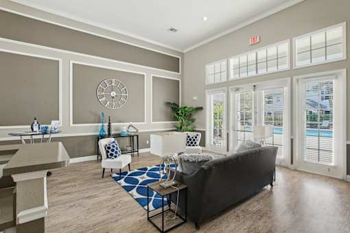 A living room with a couch, chairs, and a table.