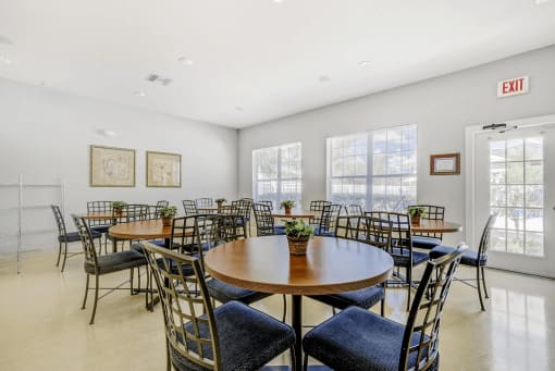 Clubhouse dining area with multiple tables and chairs